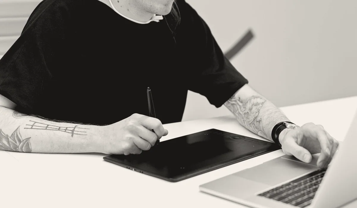 An illustrator drawing on a graphics tablet.