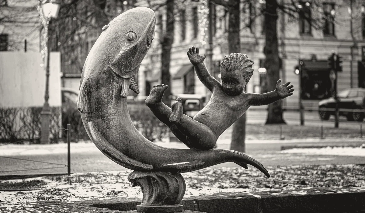 A bronze fountain figure in a town square.