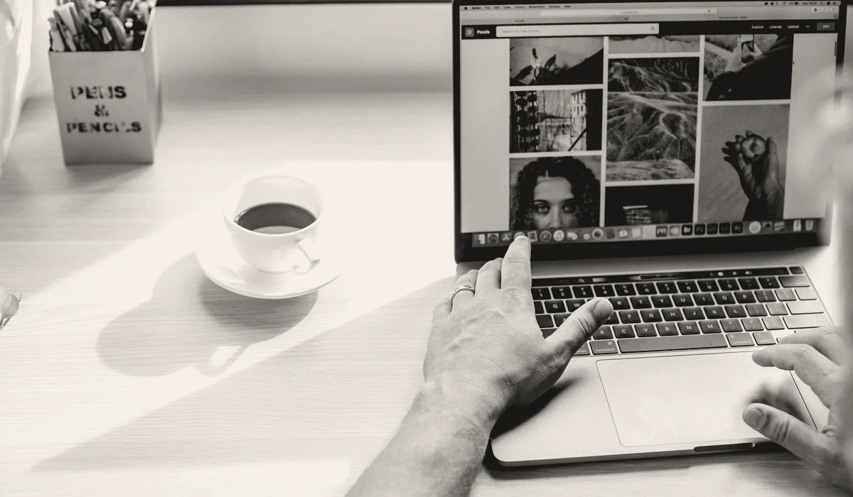 Searching on a laptop at a desk.