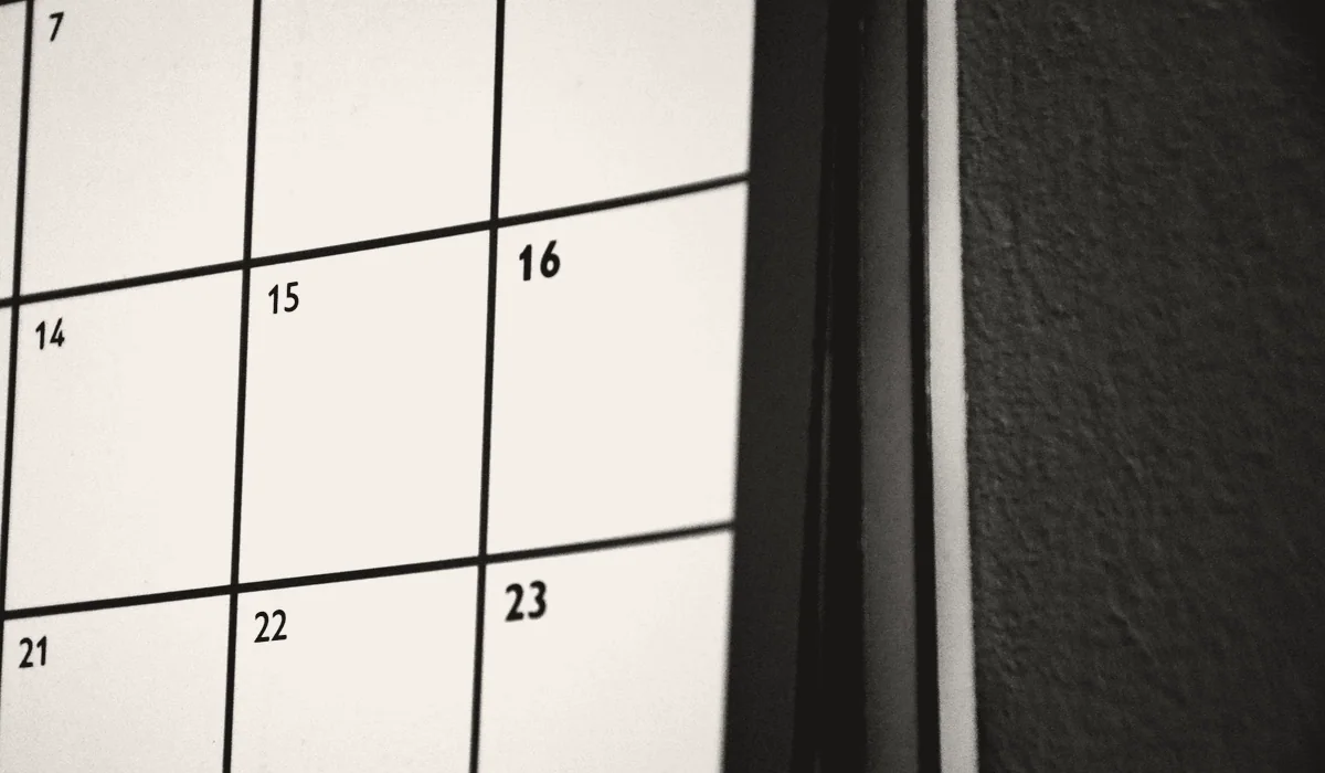 A wall planner marked up with a schedule.